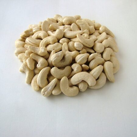 Fresh and creamy cashews arranged in heap.
