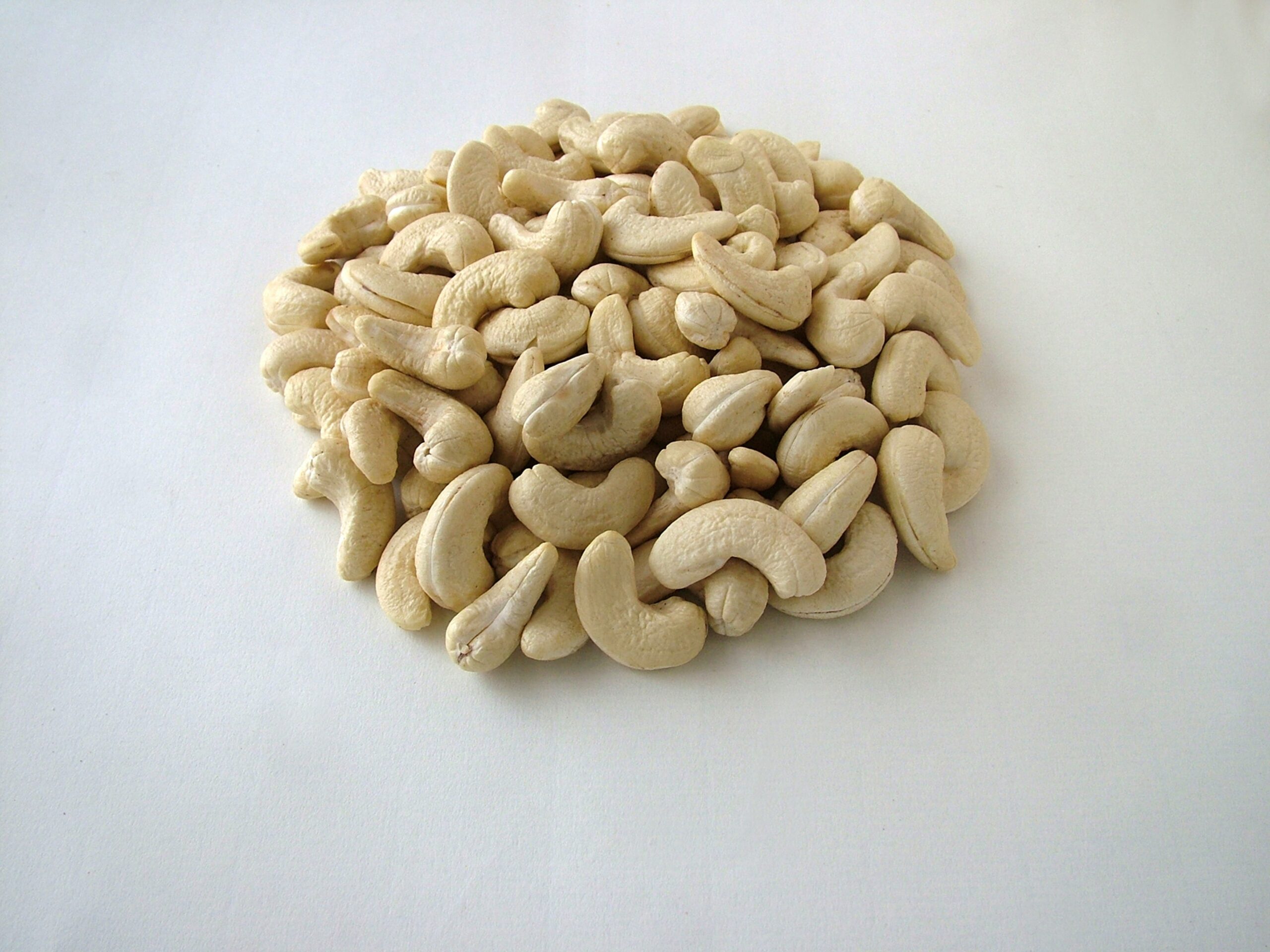 Fresh and creamy cashews arranged in heap.
